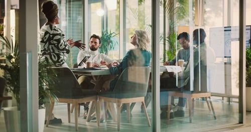 people sitting in a board room having a meeting