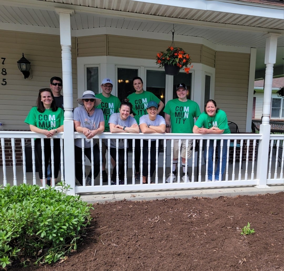 volunteer day team standing on a porch together