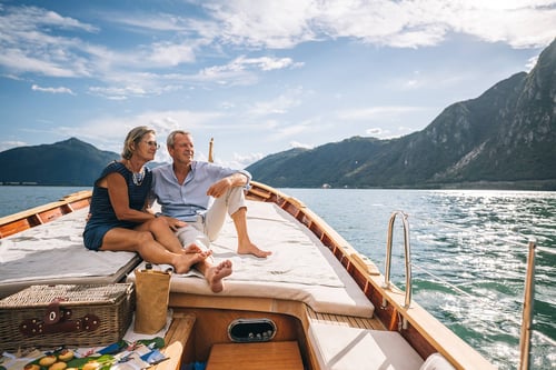 couple sitting on a boat traveling in retirement