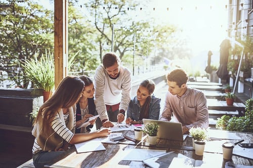 group of young professionals working together in an outdoor space
