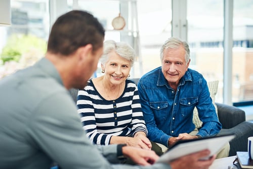 mature couple smiling at an advisor