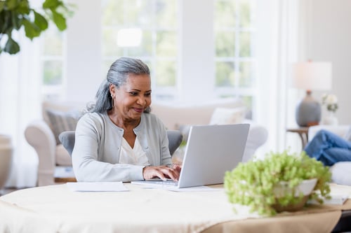 mature woman typing laptop