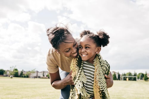 mother and daughter outdoors and smiling