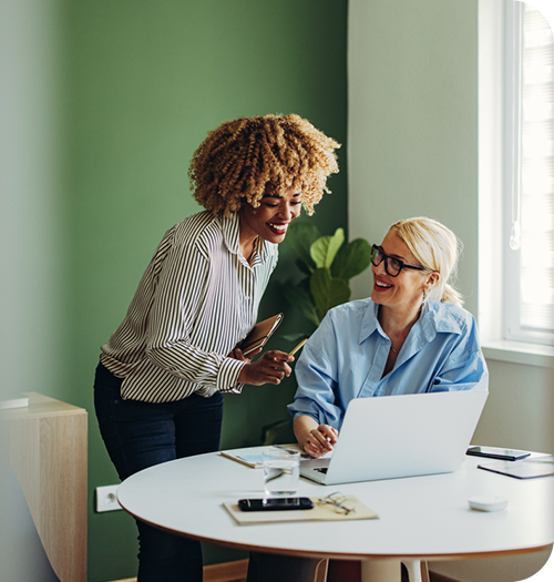 businesswomen working together at laptop
