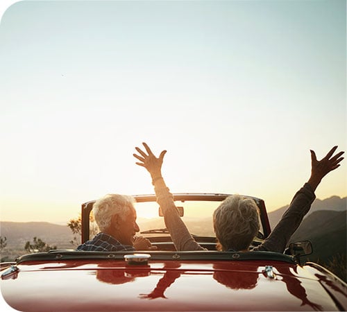 wealth management mature couple in convertible