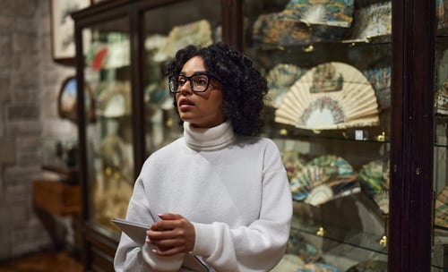 woman holding tablet in museum collectibles