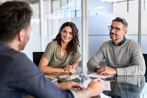 young couple meeting with a financial advisor