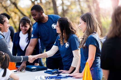 young woman volunteer shaking hands