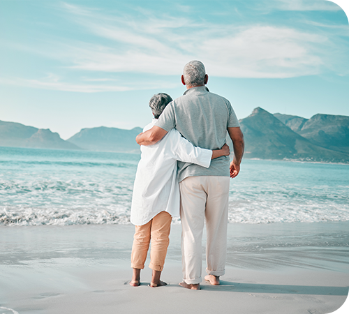 mature-couple-on-beach-looking-at-the-water
