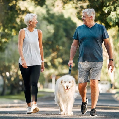 mature-couple-walking-a-dog-and-looking-at-eachother-in-a-park-400x400 mature-couple-walking-a-dog-and-looking-at-eachother-in-a-park-400x400